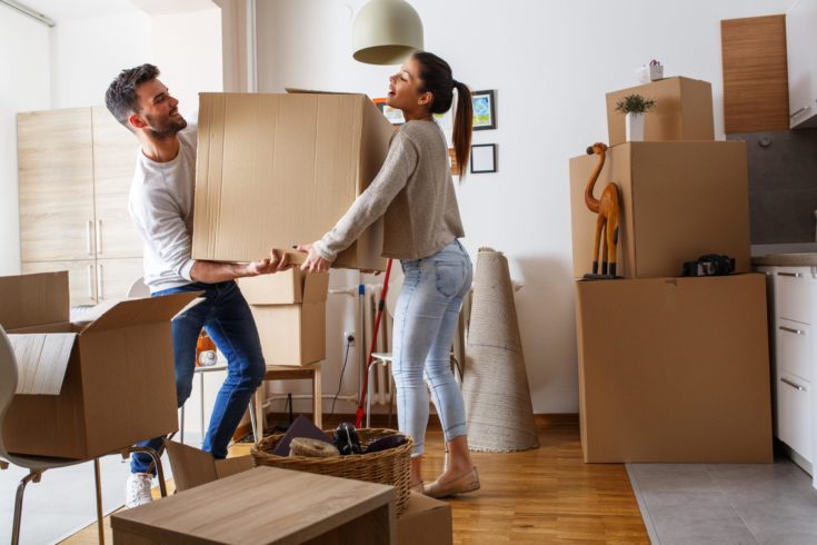 AdobeStock_135240473-scaled-735×0-c-default Couple carrying a big box