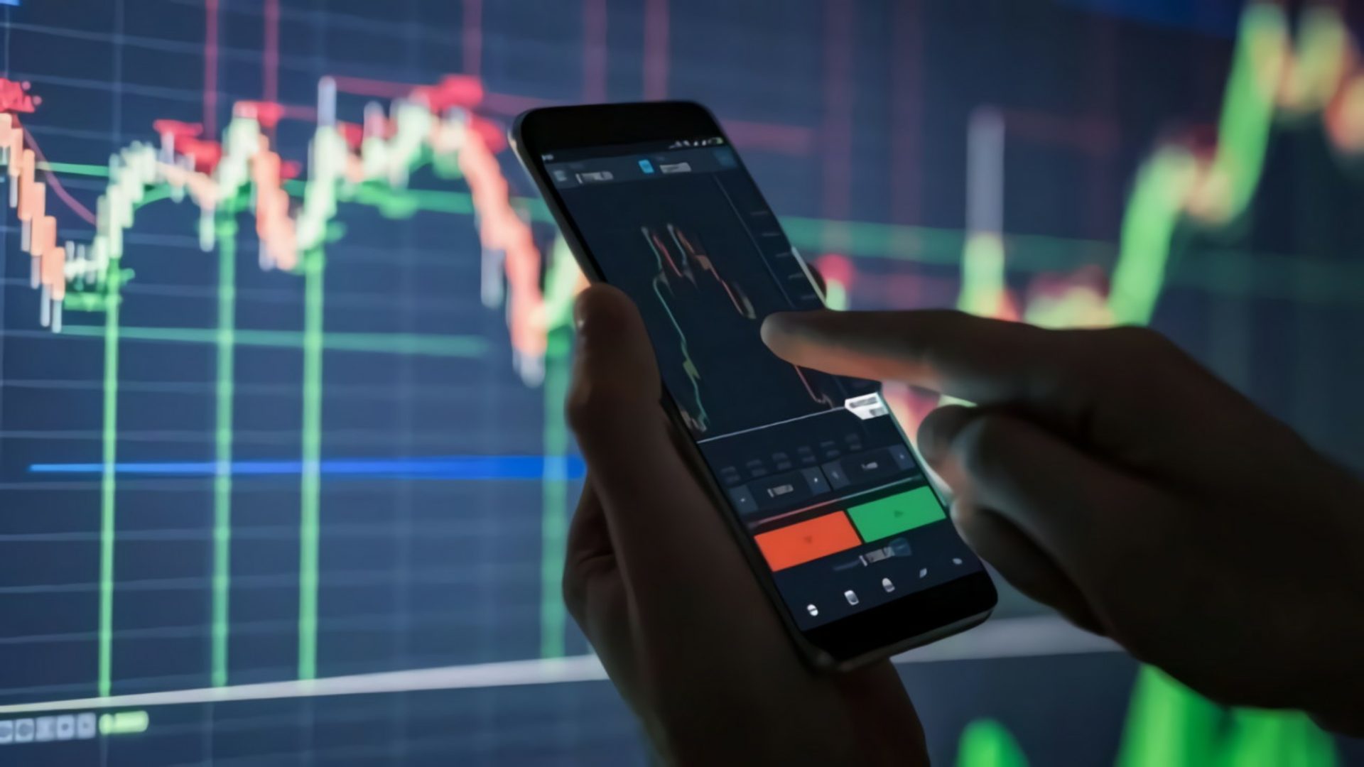Hand holding a mobile phone monitoring stock-related information
